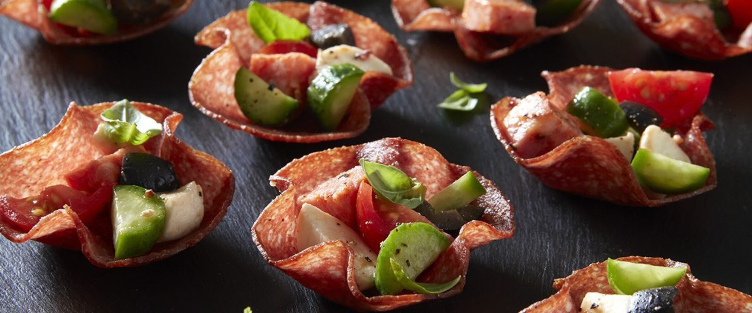Salami cups with cheese, tomato, and cucumber