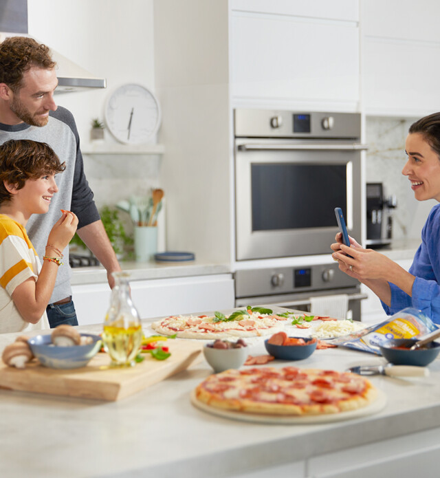 Mom and son making a sandwich at a kitchen