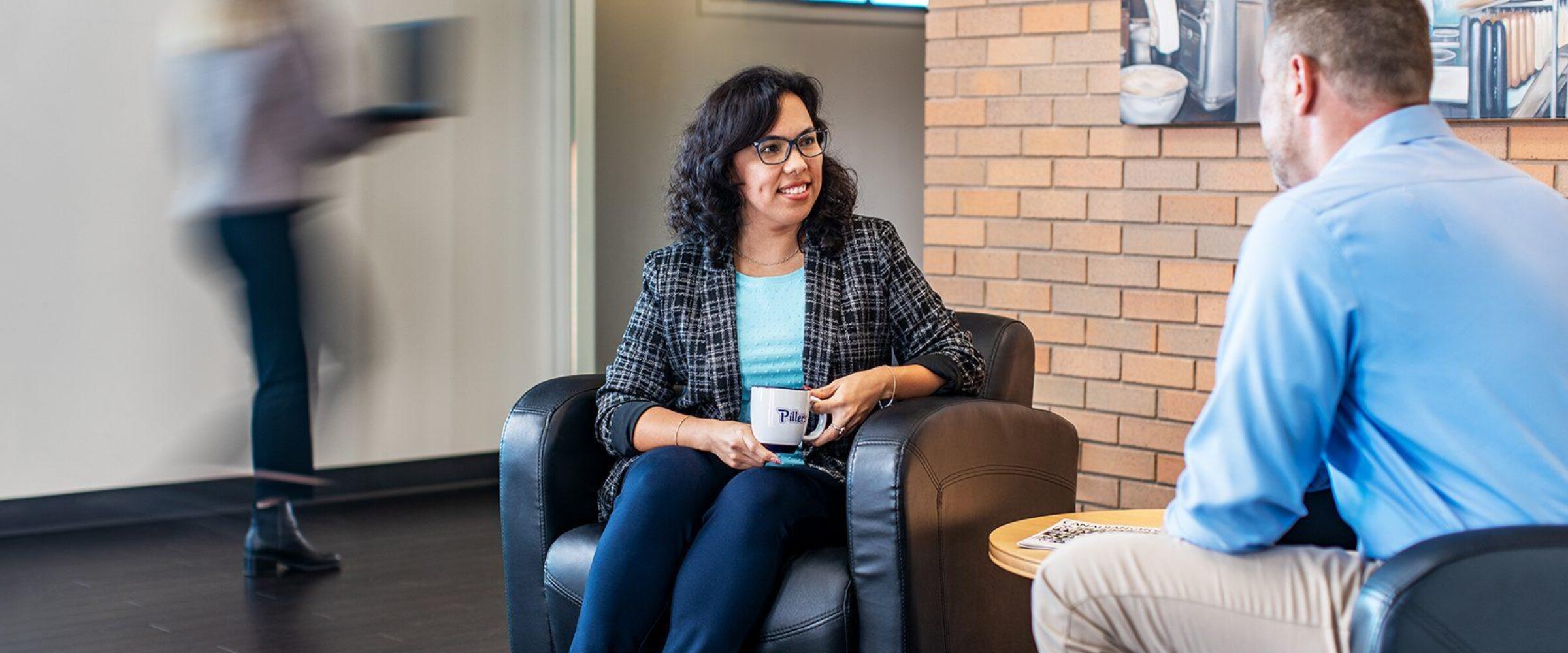 Two employees sitting and talking