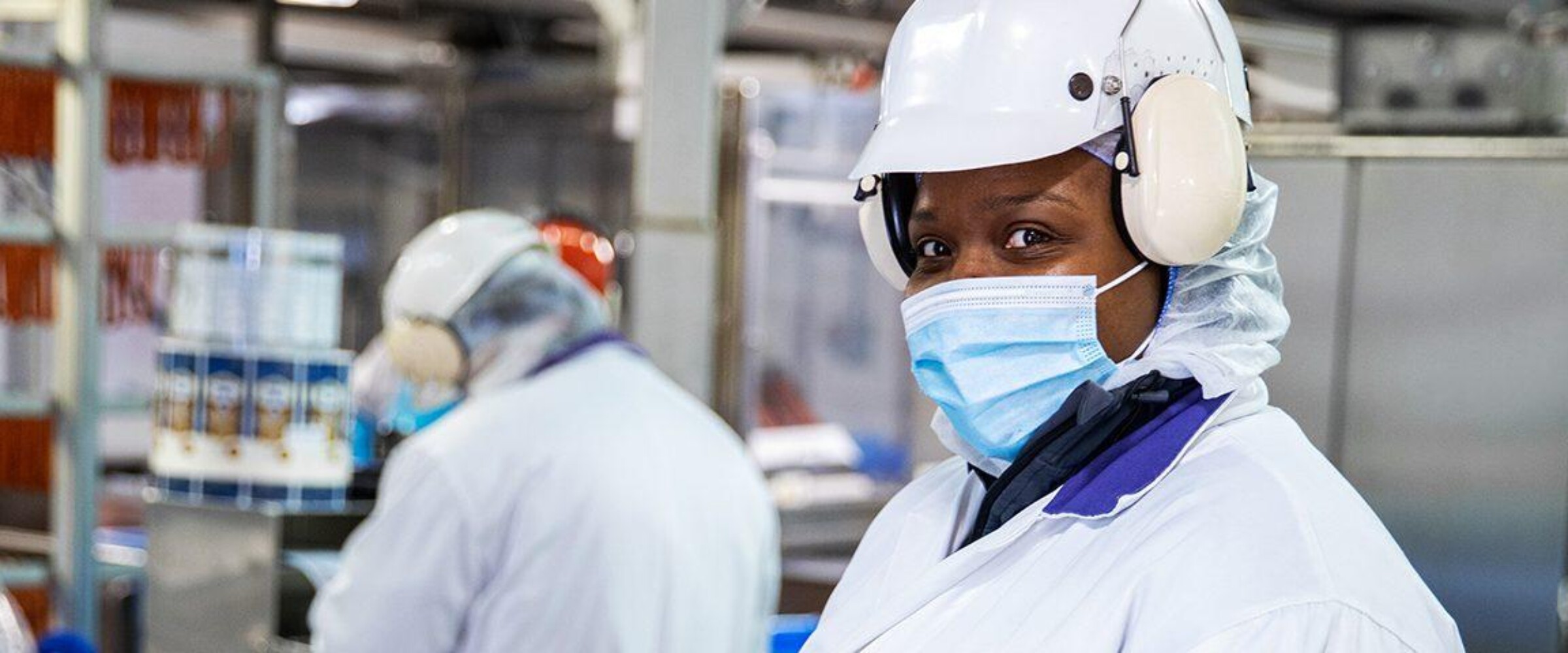 Employee looking at camera in production plant