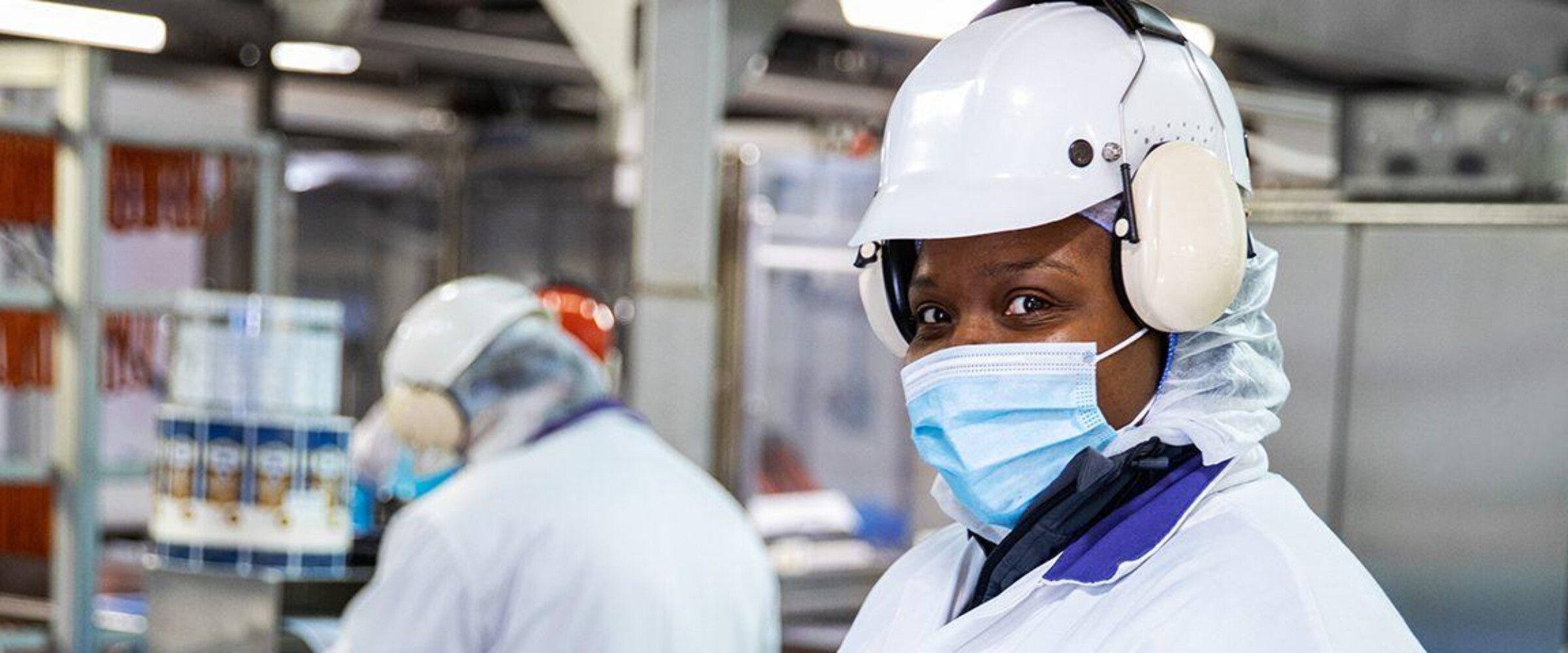 Employee looking at camera in production plant