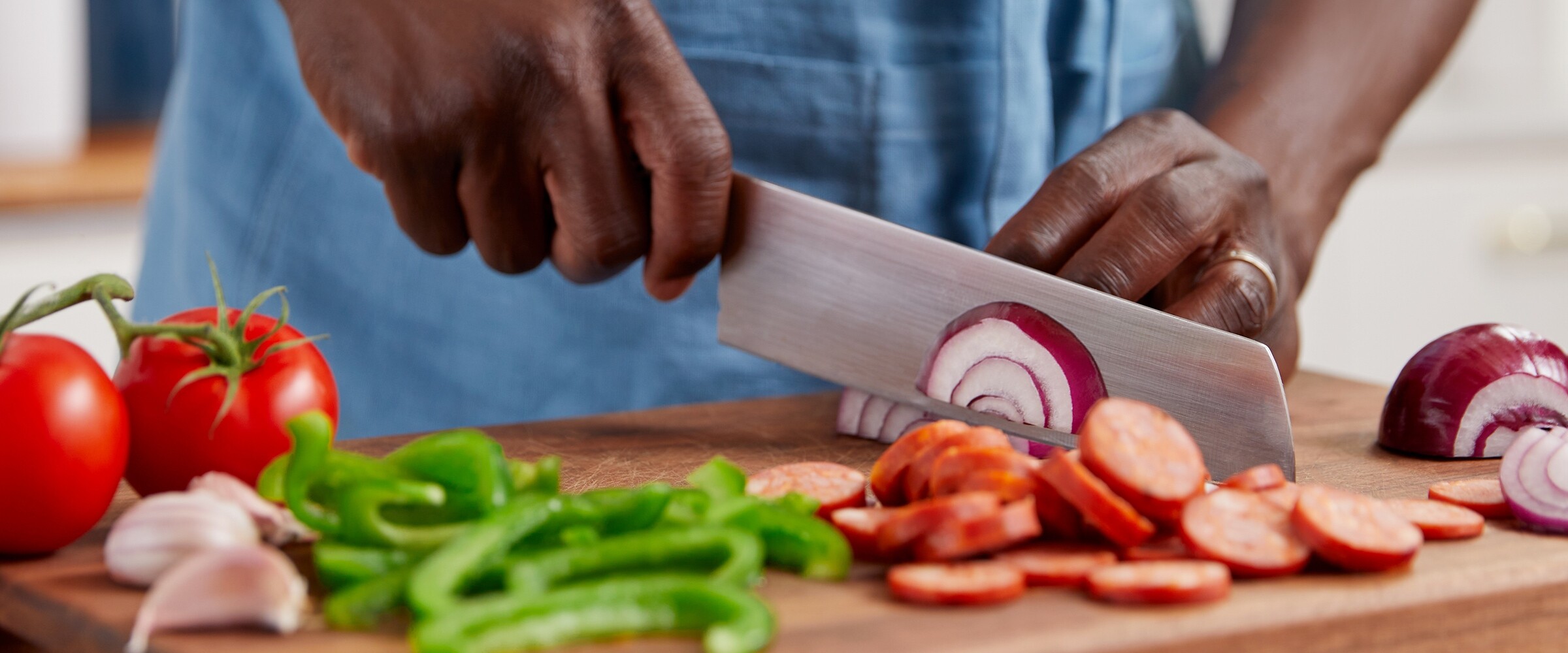 Person chopping vegetables on a cutting board.