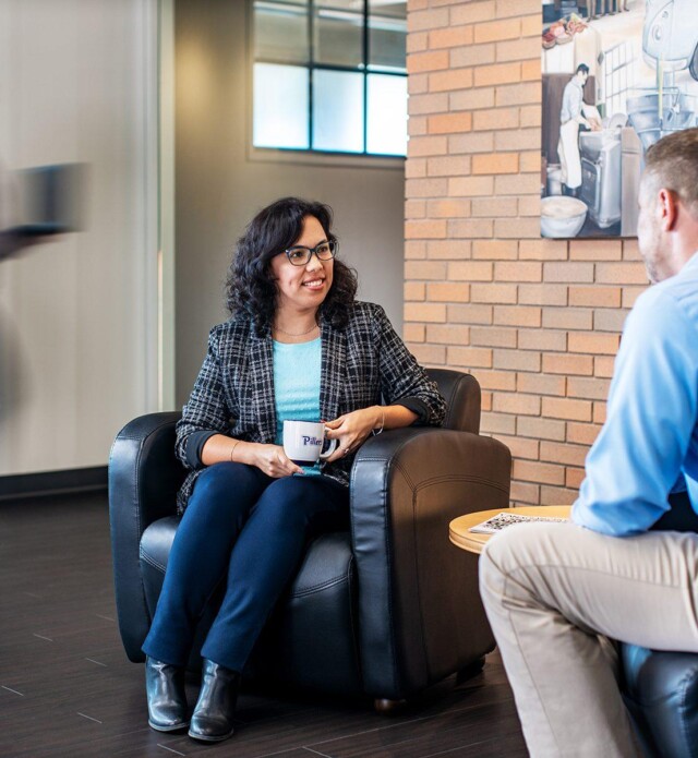 Two employees sitting and talking