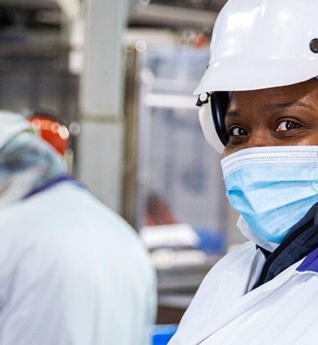 Employee looking at camera in production plant