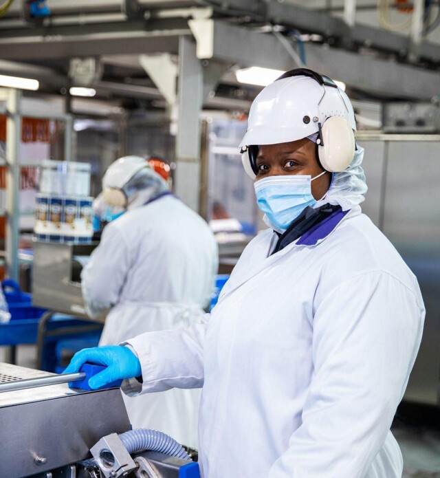 Employee looking at camera in production plant