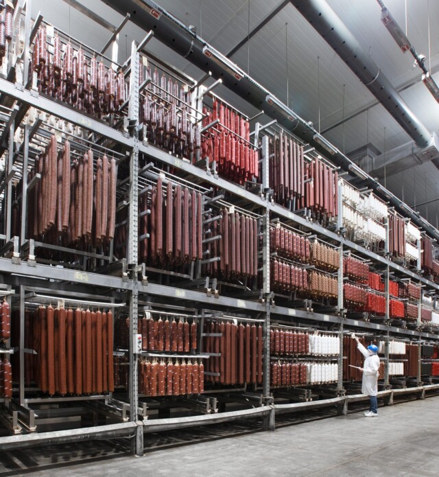 Piller's worker doing inventory of meat products in a temperature controlled warehouse.