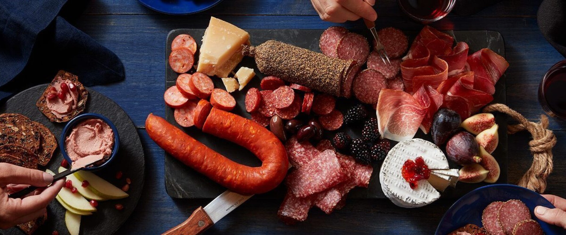 People enjoying a charcuterie board