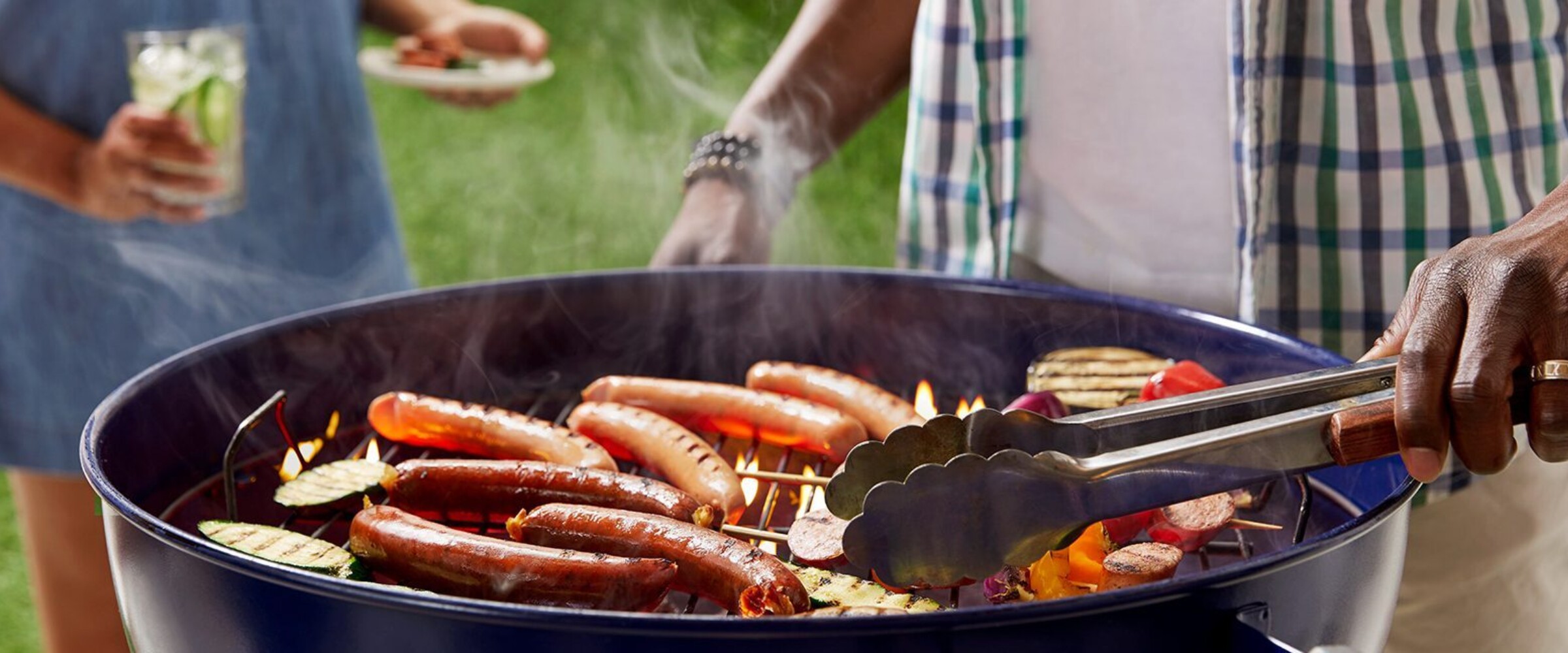 Two people barbequing