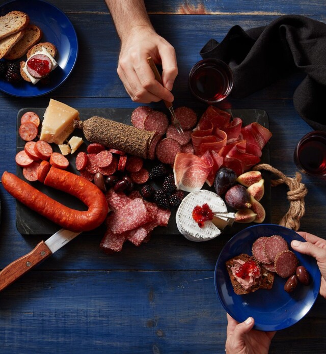 People enjoying a charcuterie board