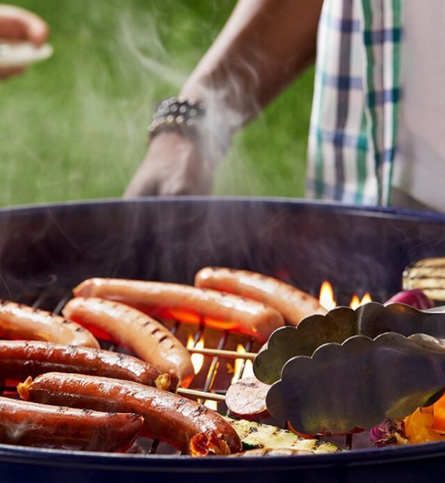 two people barbequing