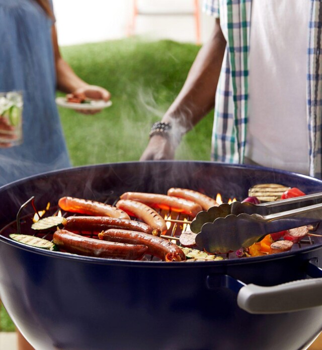 Two people barbequing