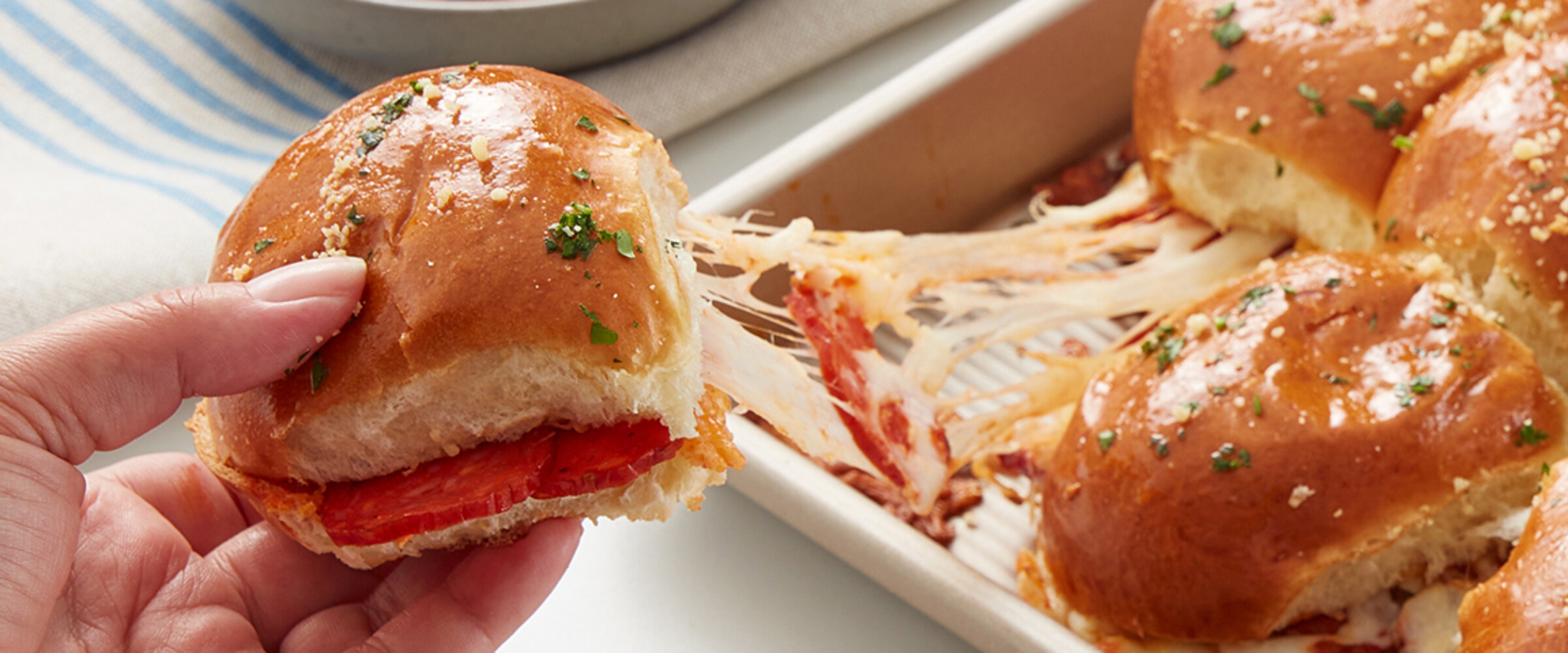 Pizza sliders with hand pulling them