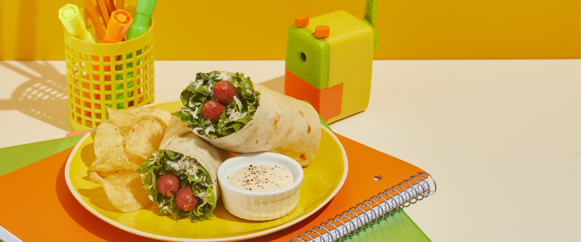 Chicken Wrap on a plate with chips and dip