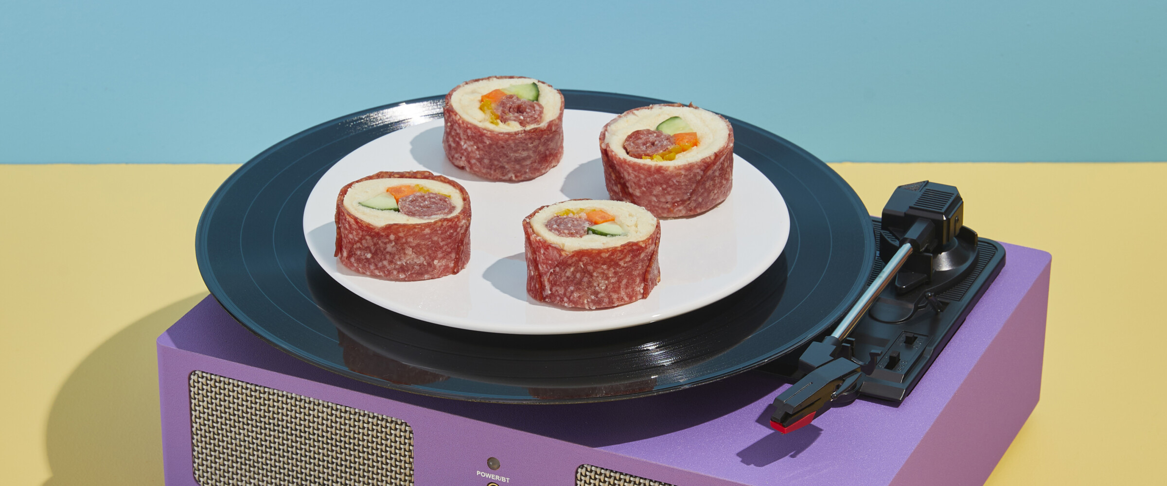 Sushi made of of Salami on a record player spinning