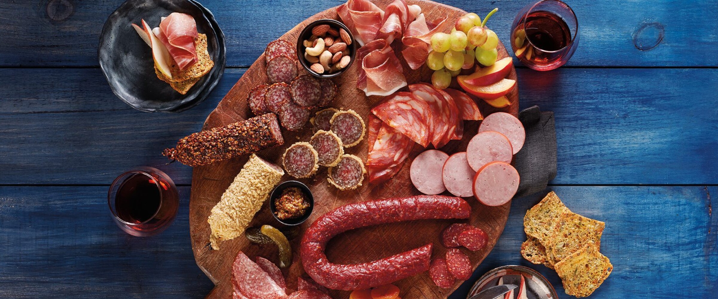 Charcuterie board with meat, fruit and crackers