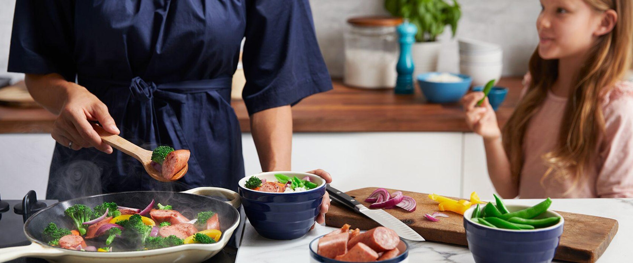 Mother and daughter cooking dinner