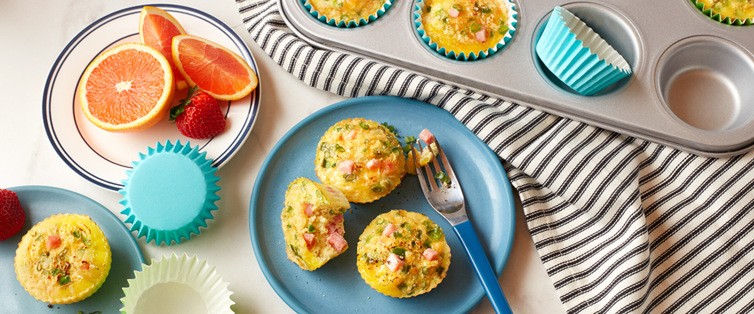 egg bites with ham and cheese on a blue plate