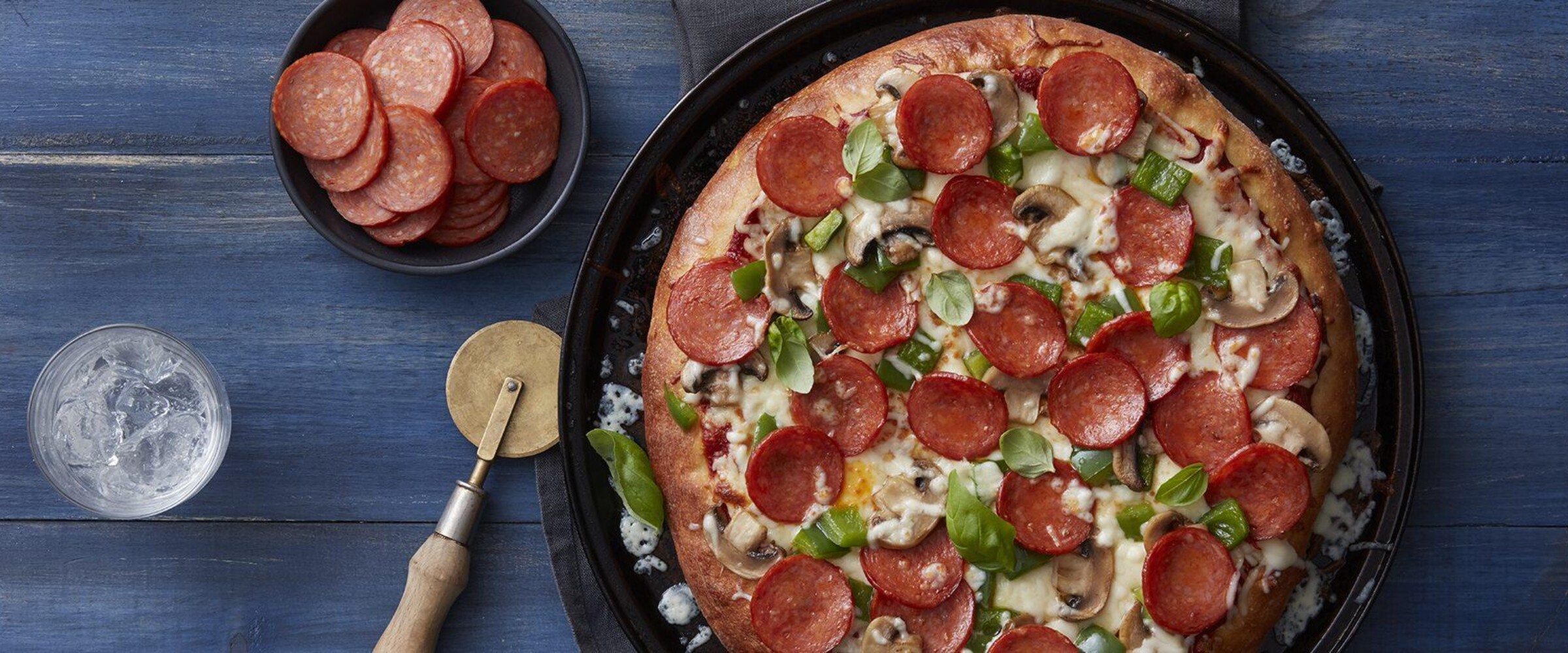 Classic Pepperoni Pizza with basil and mushrooms