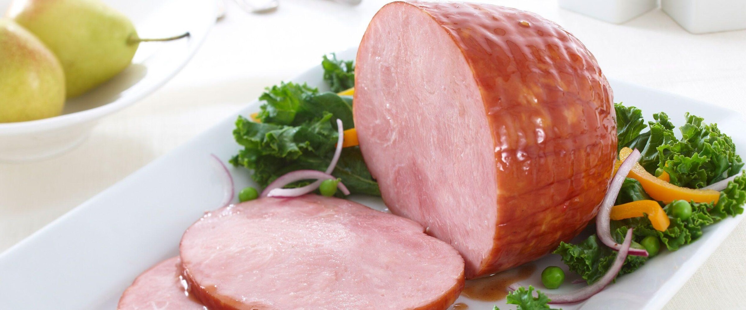 Honey glazed ham on white plate