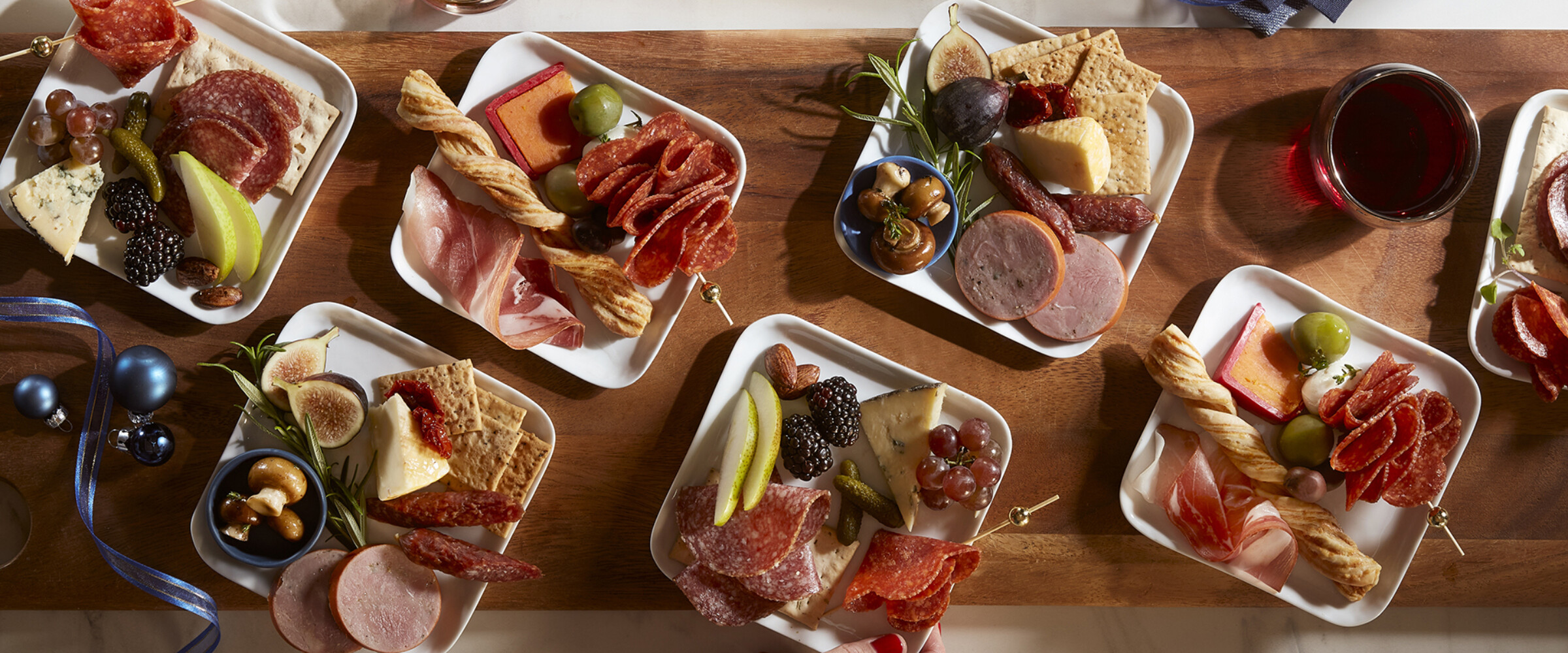 Holiday Charcuterie small plates with meats, cheese, fruits and vegetables.