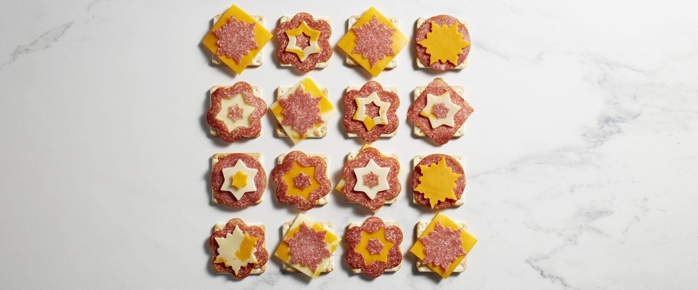 Salami and cheese and crackers cut into snowflake shapes