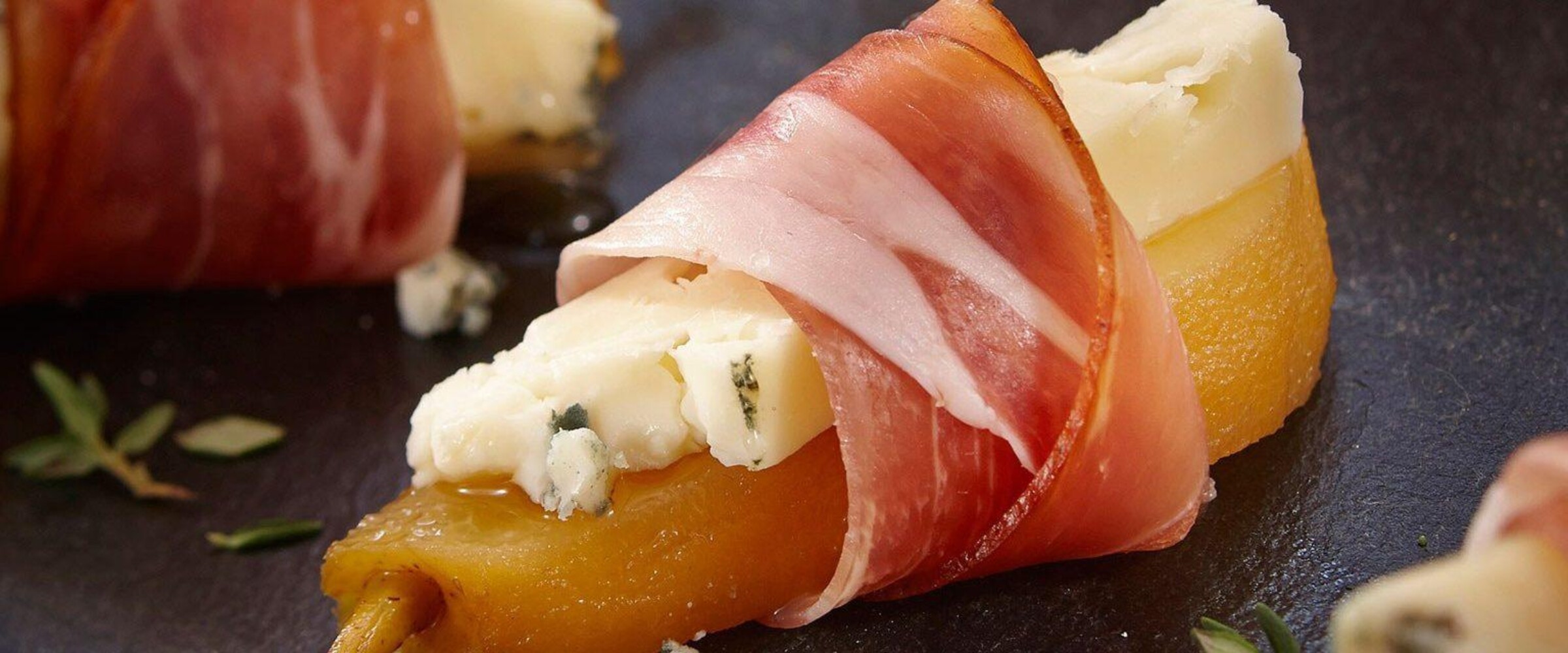 Pear wrapped with speck prosciutto and cheese
