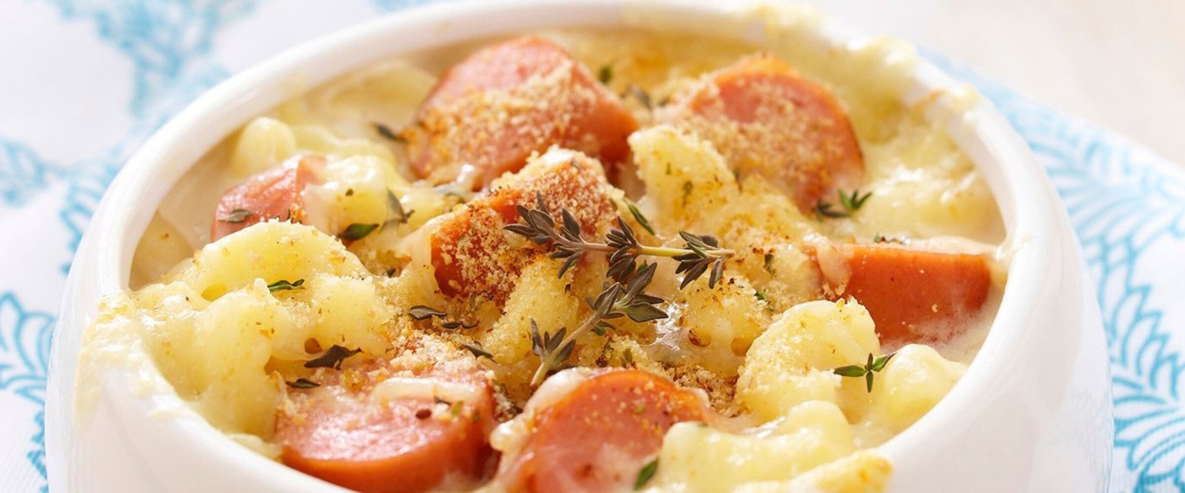 Macaroni casserole with sausage in a white bowl