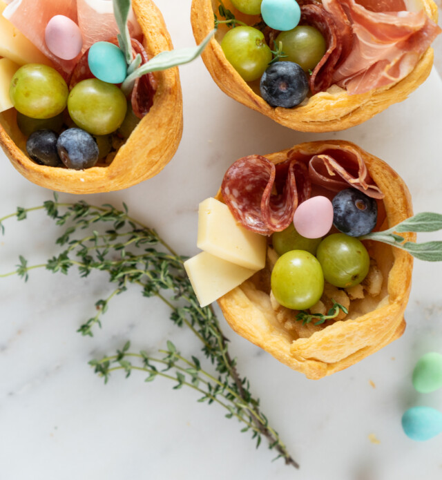 pastry nests filled with charcuterie items on a platter