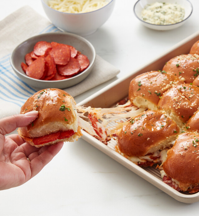 Pizza sliders with hand pulling them