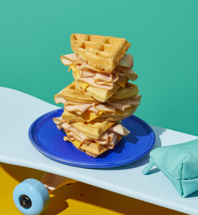 Waffles Stacked with Sliced Chicken on a plate