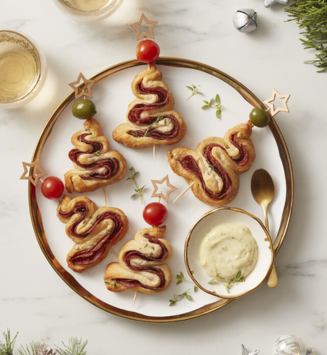 Pastry and salami cooked in the shape of a tree on a serving plate
