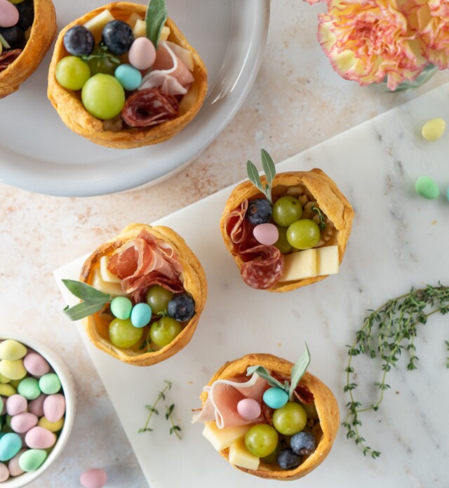 pastry nests filled with charcuterie items on a platter