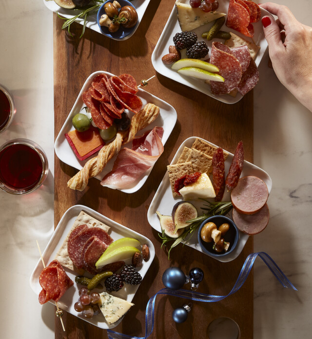 Holiday Charcuterie small plates with meats, cheese, fruits and vegetables.