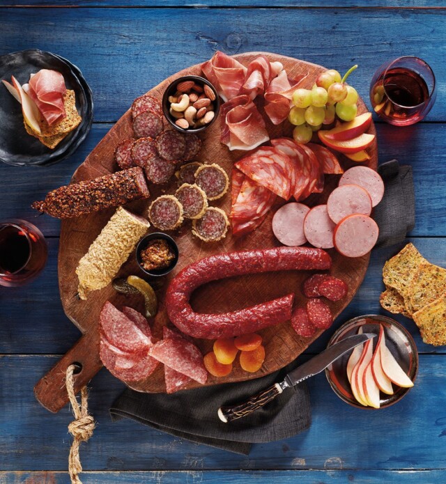 Charcuterie board with meat, fruit and crackers