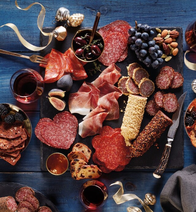 Charcuterie board with shaped salamis, coated salami and with gold ribbon