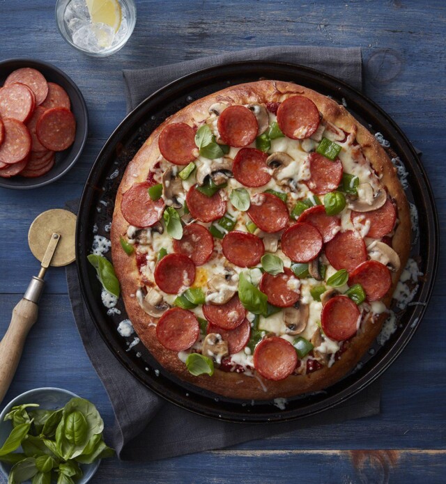 Classic Pepperoni Pizza with basil and mushrooms