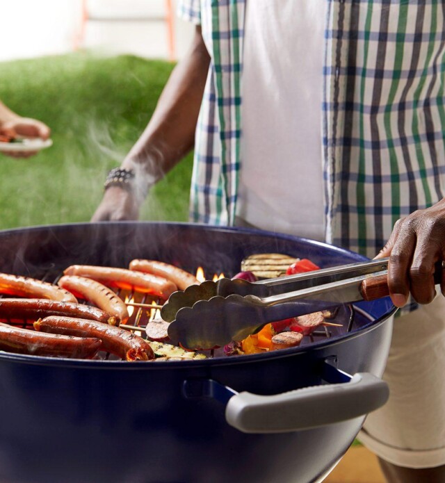 two people barbequing