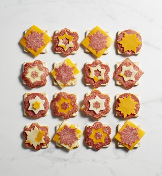Salami and cheese and crackers cut into snowflake shapes