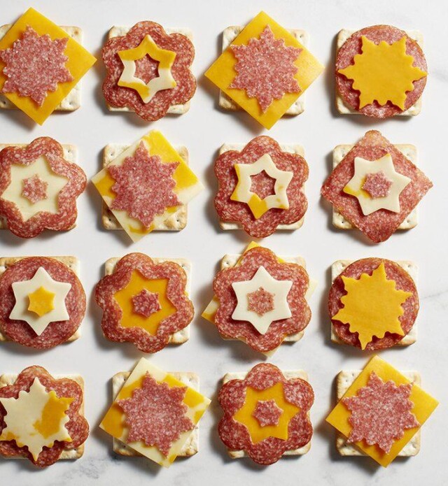 Salami and cheese and crackers cut into snowflake shapes